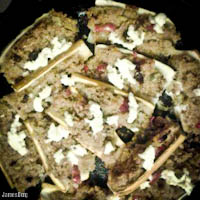 Zucchini stuffed with quinoa spiced with raisins, cardamom, paprika, cumin, onions, and sweet peppers, topped with ricotta